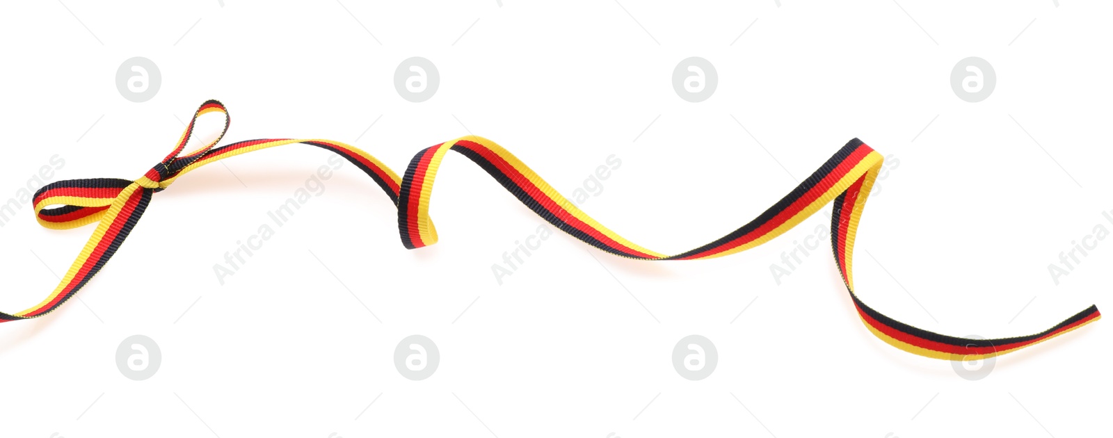 Photo of Ribbon with bow in colors of German flag isolated on white