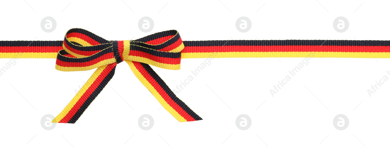 Photo of Ribbon with bow in colors of German flag isolated on white, top view