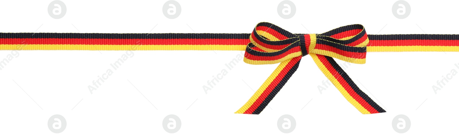 Photo of Ribbon with bow in colors of German flag isolated on white, top view