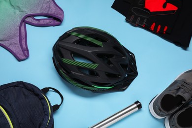 Flat lay composition with cycling accessories a on light blue background