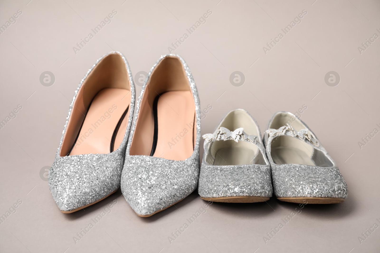 Photo of Big and small shoes on grey background