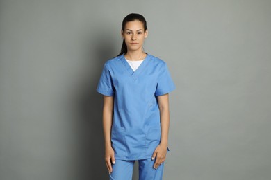 Photo of Portrait of beautiful nurse on grey background