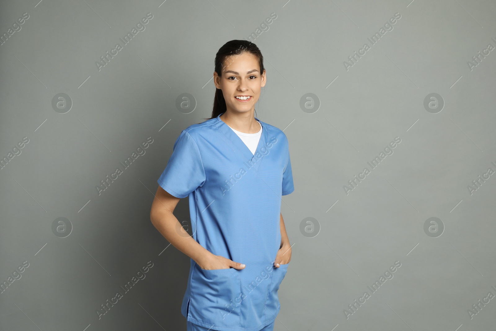 Photo of Portrait of smiling nurse on grey background