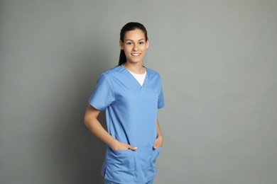 Photo of Portrait of smiling nurse on grey background