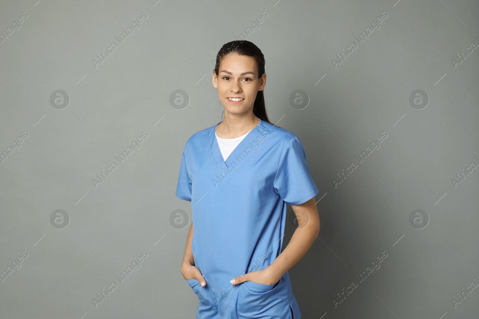 Photo of Portrait of smiling nurse on grey background