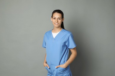 Portrait of smiling nurse on grey background