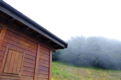 Photo of Beautiful wooden building with closed window in mountains