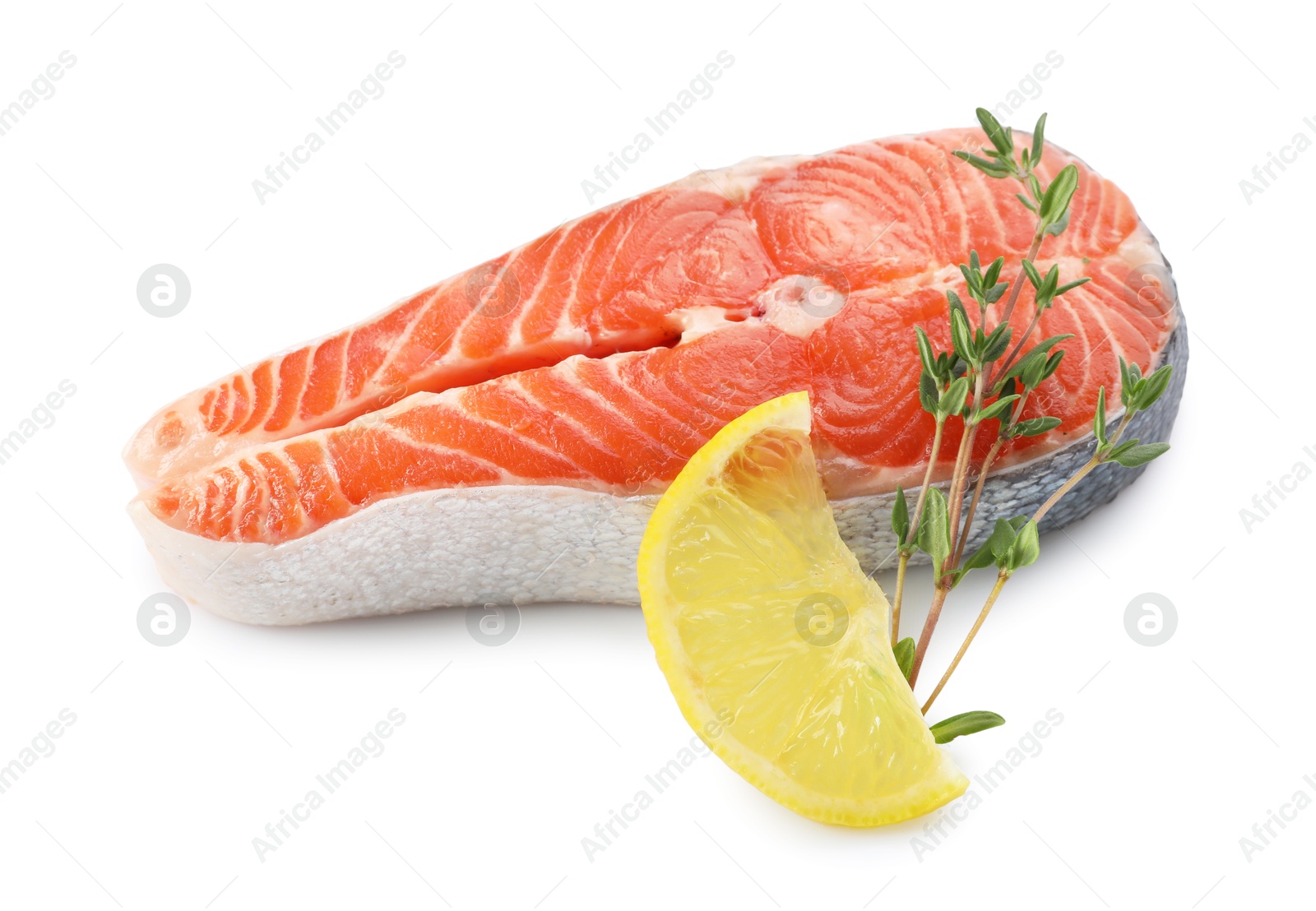 Photo of Fresh salmon steak, lemon and thyme isolated on white