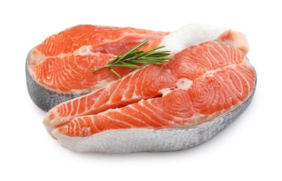 Two fresh salmon steaks and rosemary isolated on white