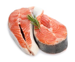 Two fresh salmon steaks and rosemary isolated on white