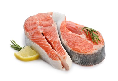 Photo of Two fresh salmon steaks, lemon and rosemary isolated on white