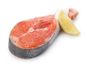 Photo of Fresh salmon steak and piece of lemon isolated on white