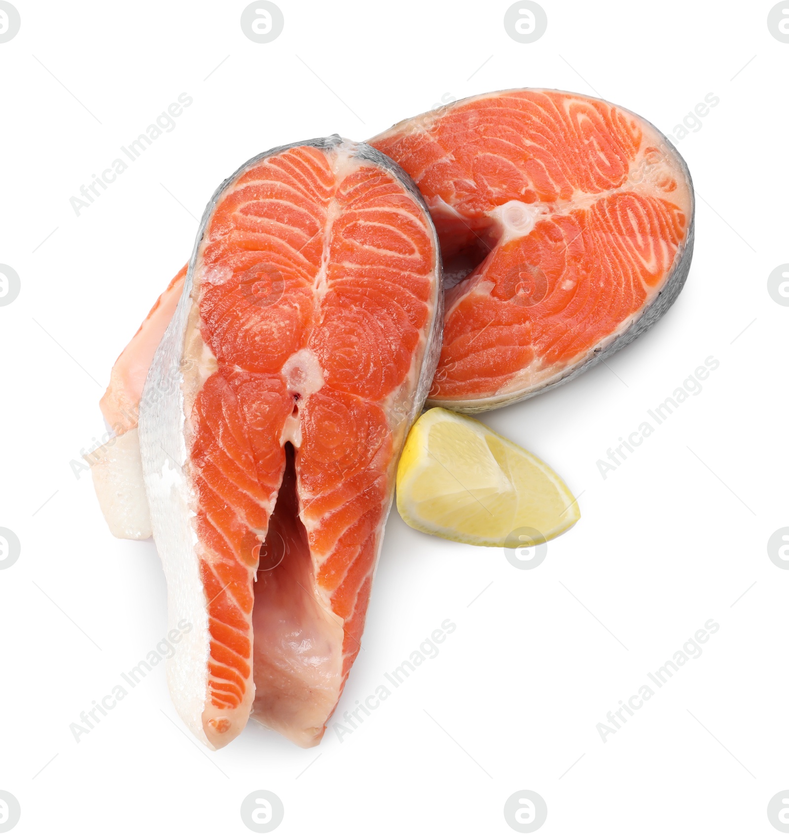 Photo of Two fresh salmon steaks and piece of lemon isolated on white, above view