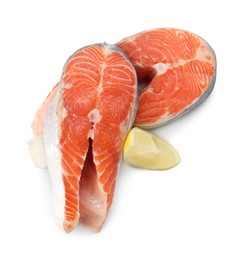 Photo of Two fresh salmon steaks and piece of lemon isolated on white, above view