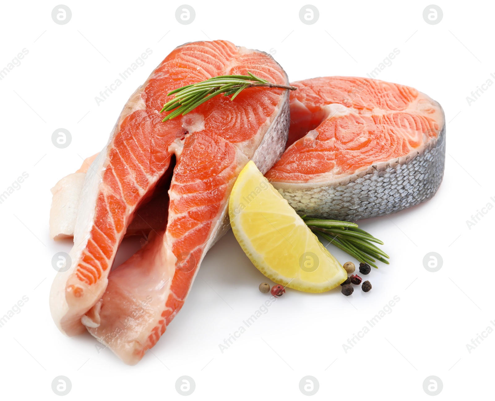 Photo of Two fresh salmon steaks, peppercorns, lemon and rosemary isolated on white