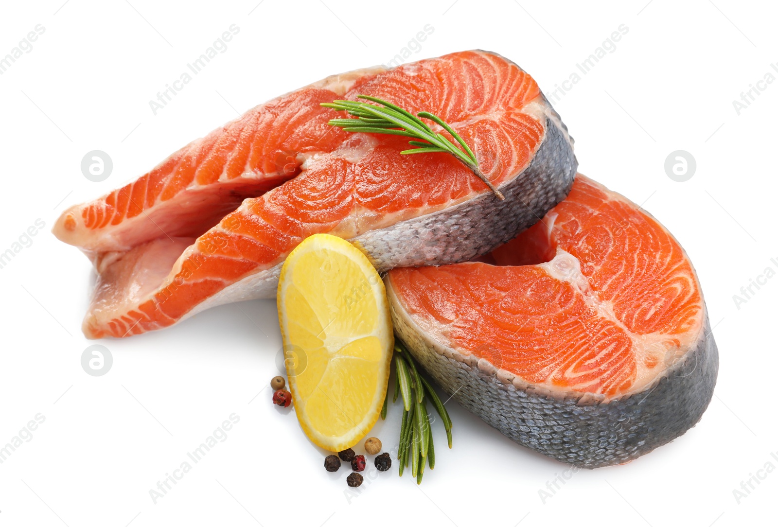 Photo of Two fresh salmon steaks, peppercorns, lemon and rosemary isolated on white