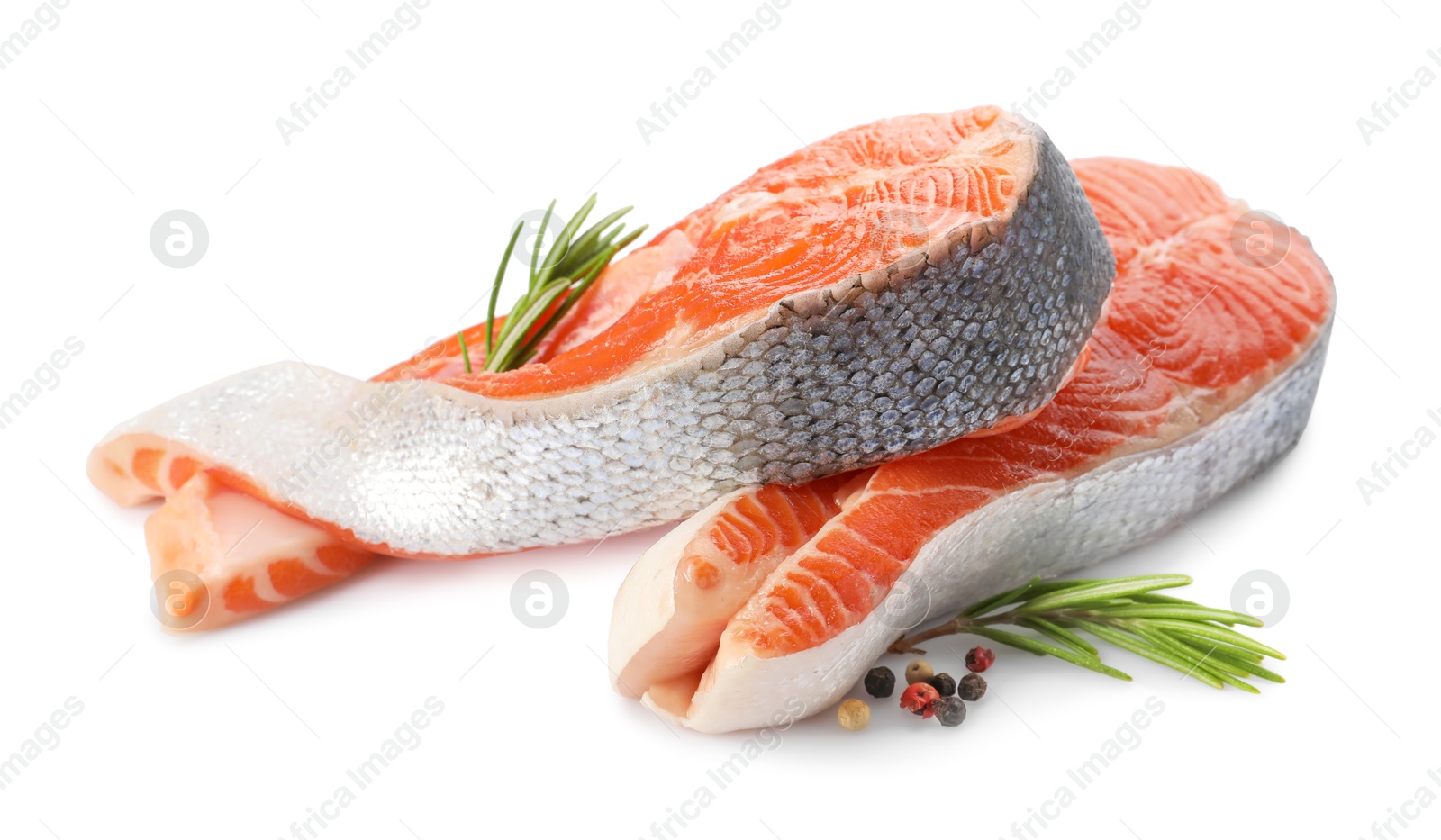 Photo of Two fresh salmon steaks, peppercorns and rosemary isolated on white