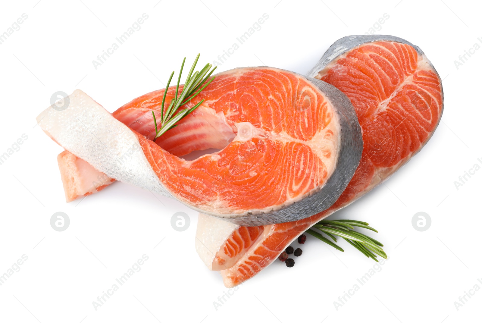 Photo of Two fresh salmon steaks, peppercorns and rosemary isolated on white, above view