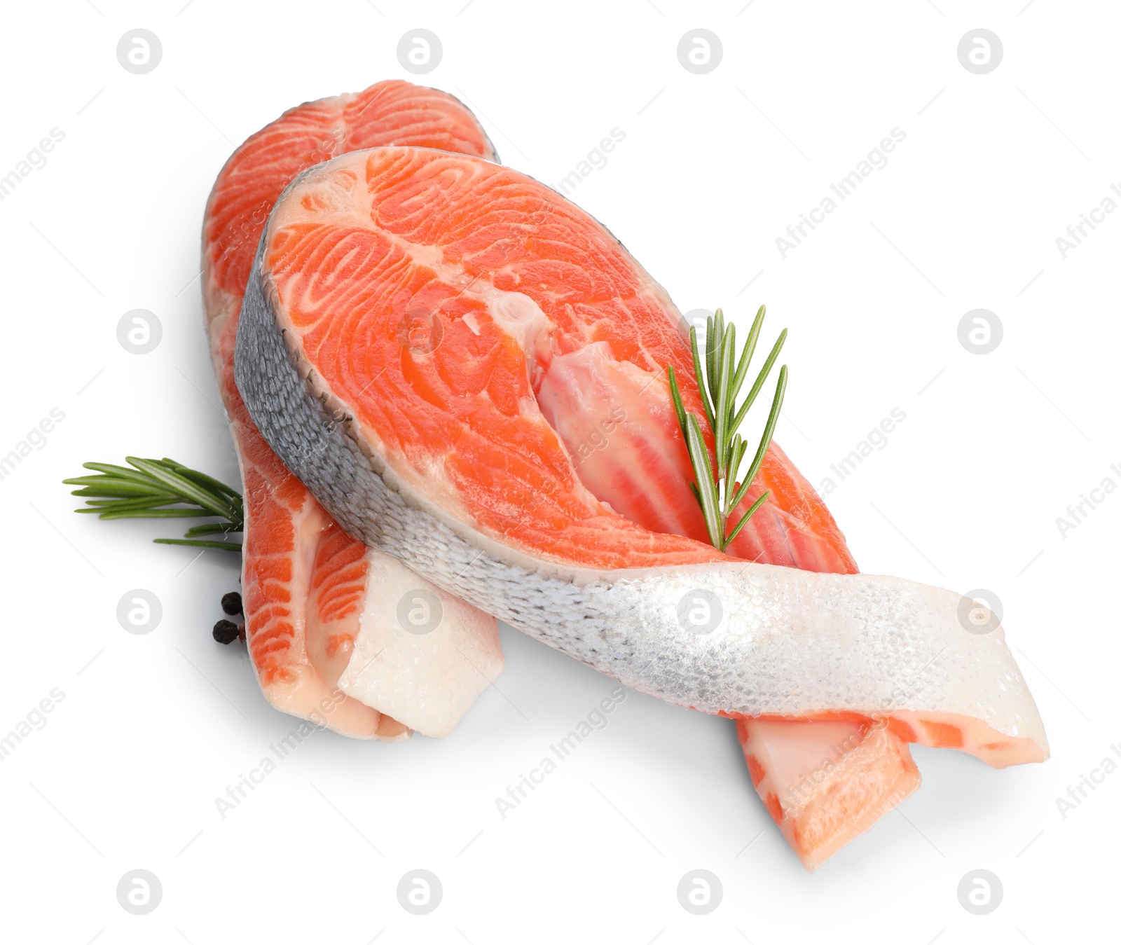 Photo of Two fresh salmon steaks, peppercorns and rosemary isolated on white