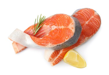 Photo of Two fresh salmon steaks, lemon and rosemary isolated on white, above view