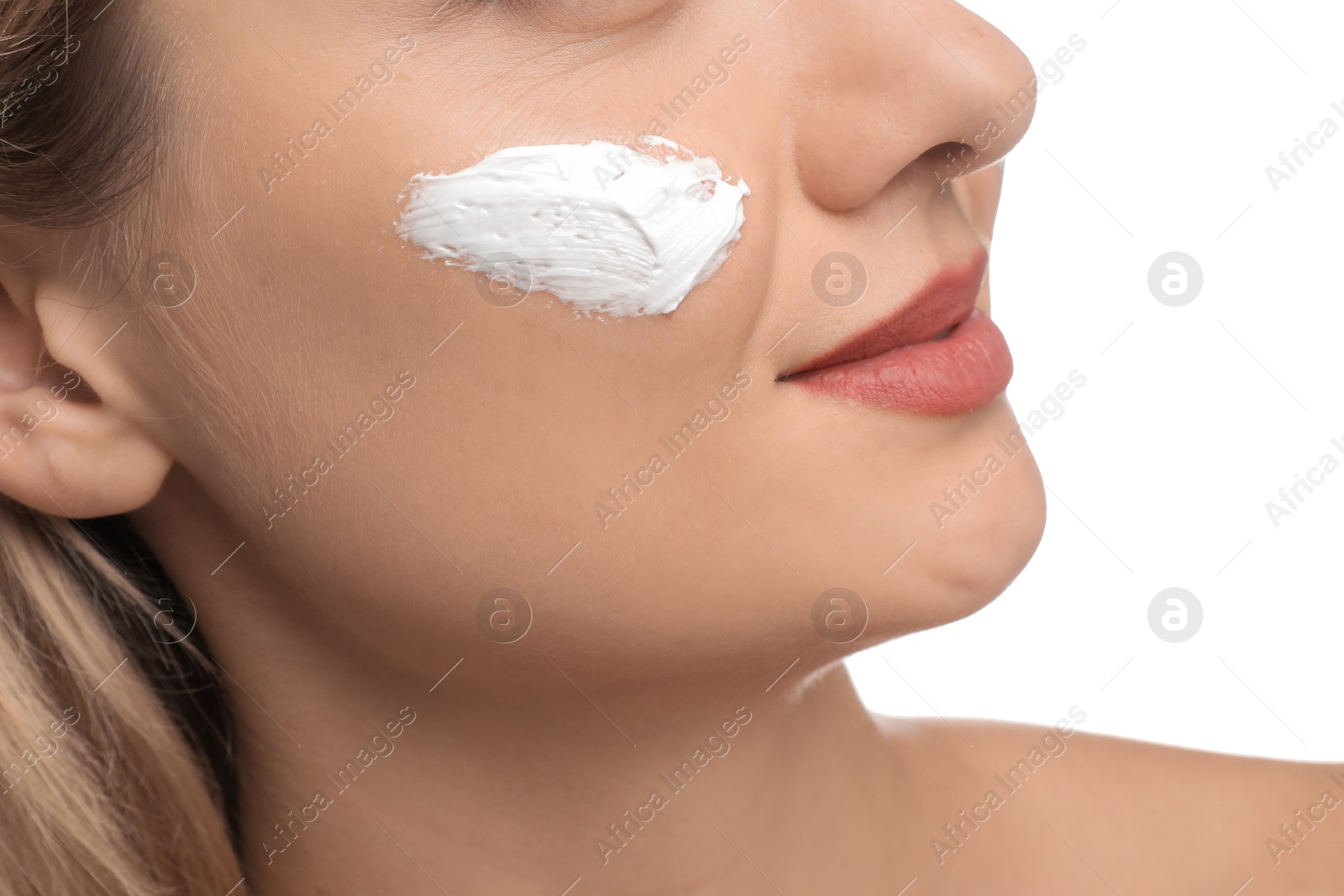 Photo of Woman with cream on her face against white background, closeup