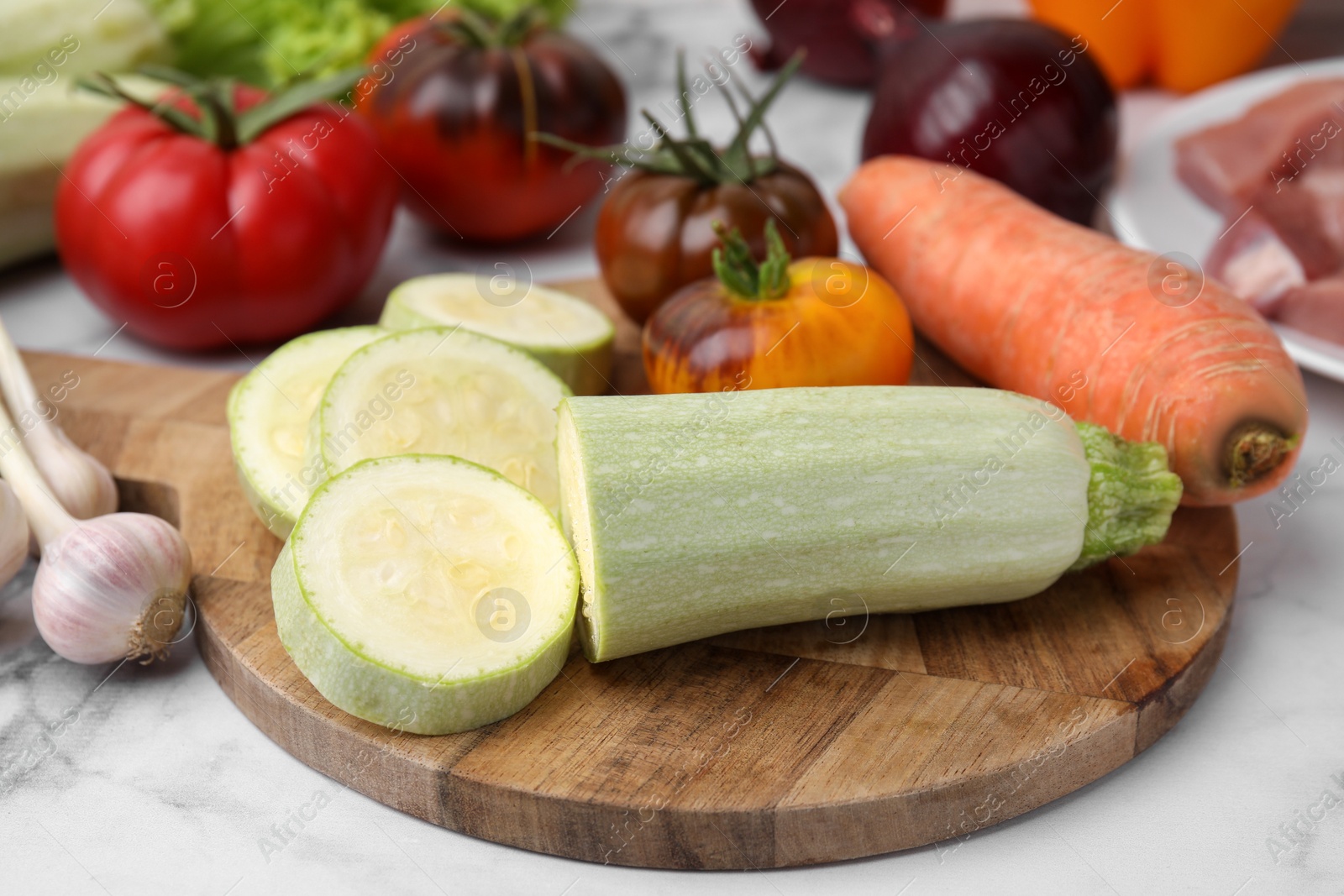 Photo of Cooking tasty stew. Different vegetables on white marble table