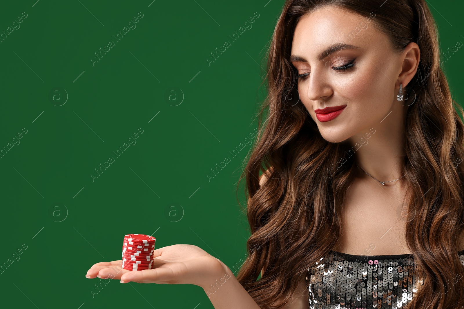 Photo of Charming woman with poker chips on green background. Space for text