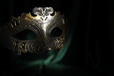 Photo of Beautiful carnival mask on black background, closeup. Space for text