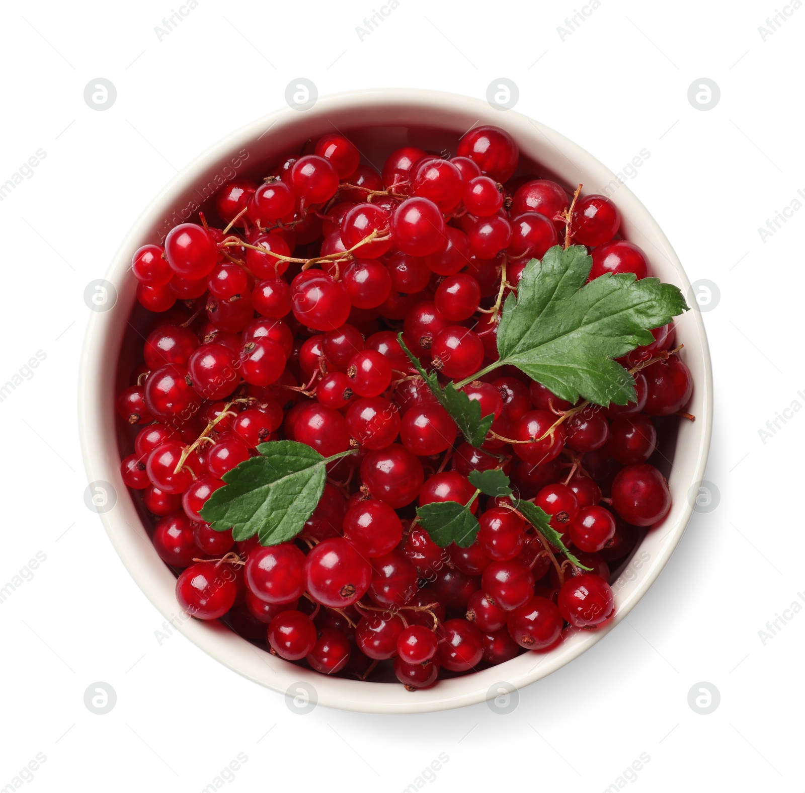 Photo of Ripe red currants with green leaves in bowl isolated on white, top view