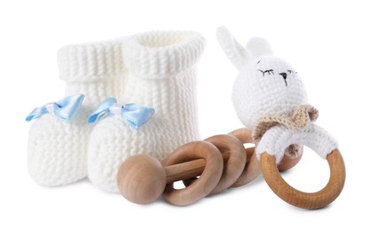 Photo of Baby rattles and booties isolated on white