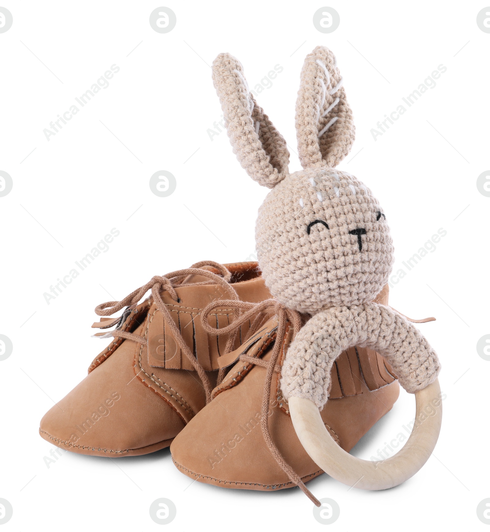 Photo of Baby rattle and booties isolated on white