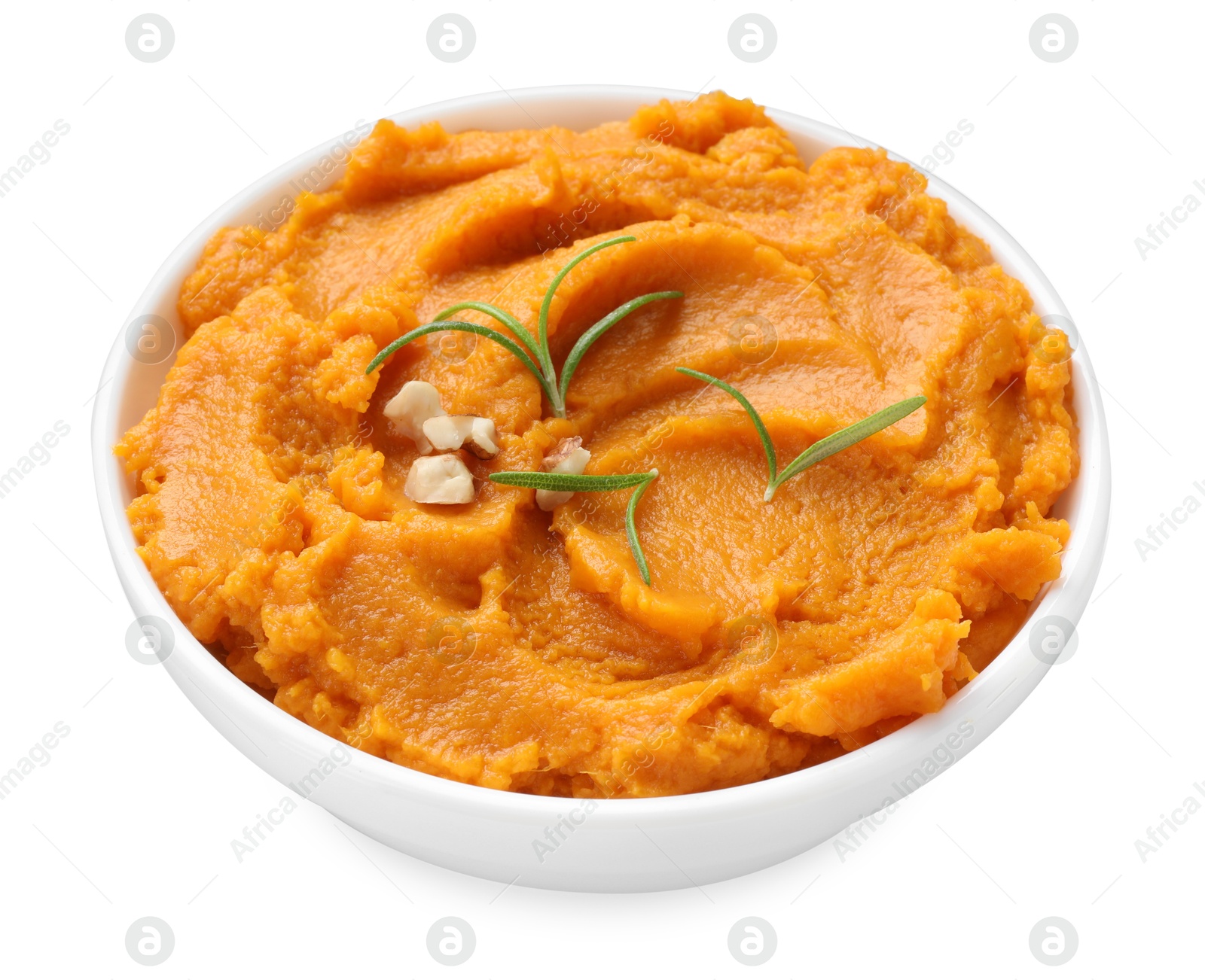 Photo of Delicious mashed sweet potatoes with rosemary and nuts in bowl isolated on white