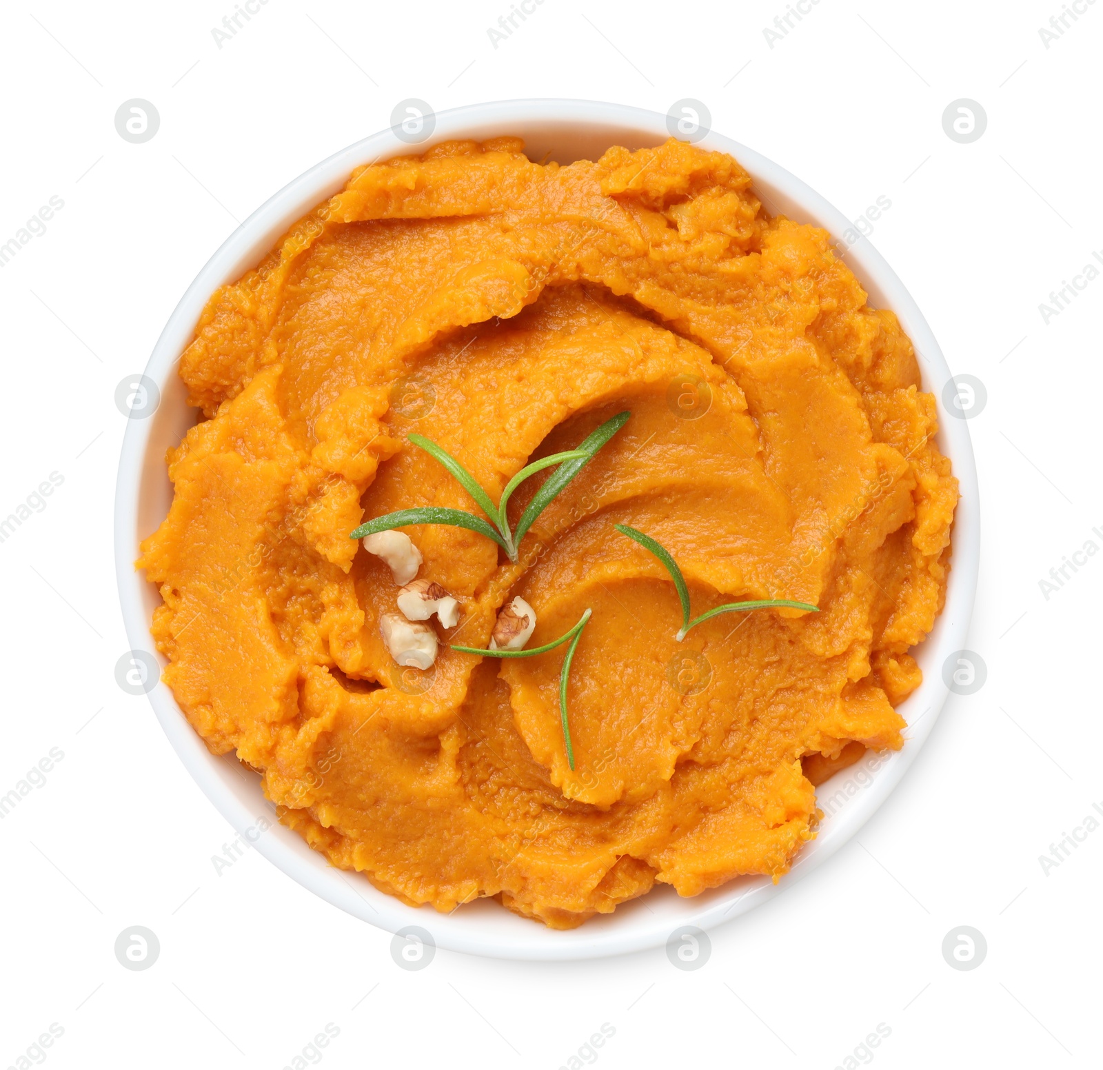 Photo of Delicious mashed sweet potatoes with rosemary and nuts in bowl isolated on white, top view