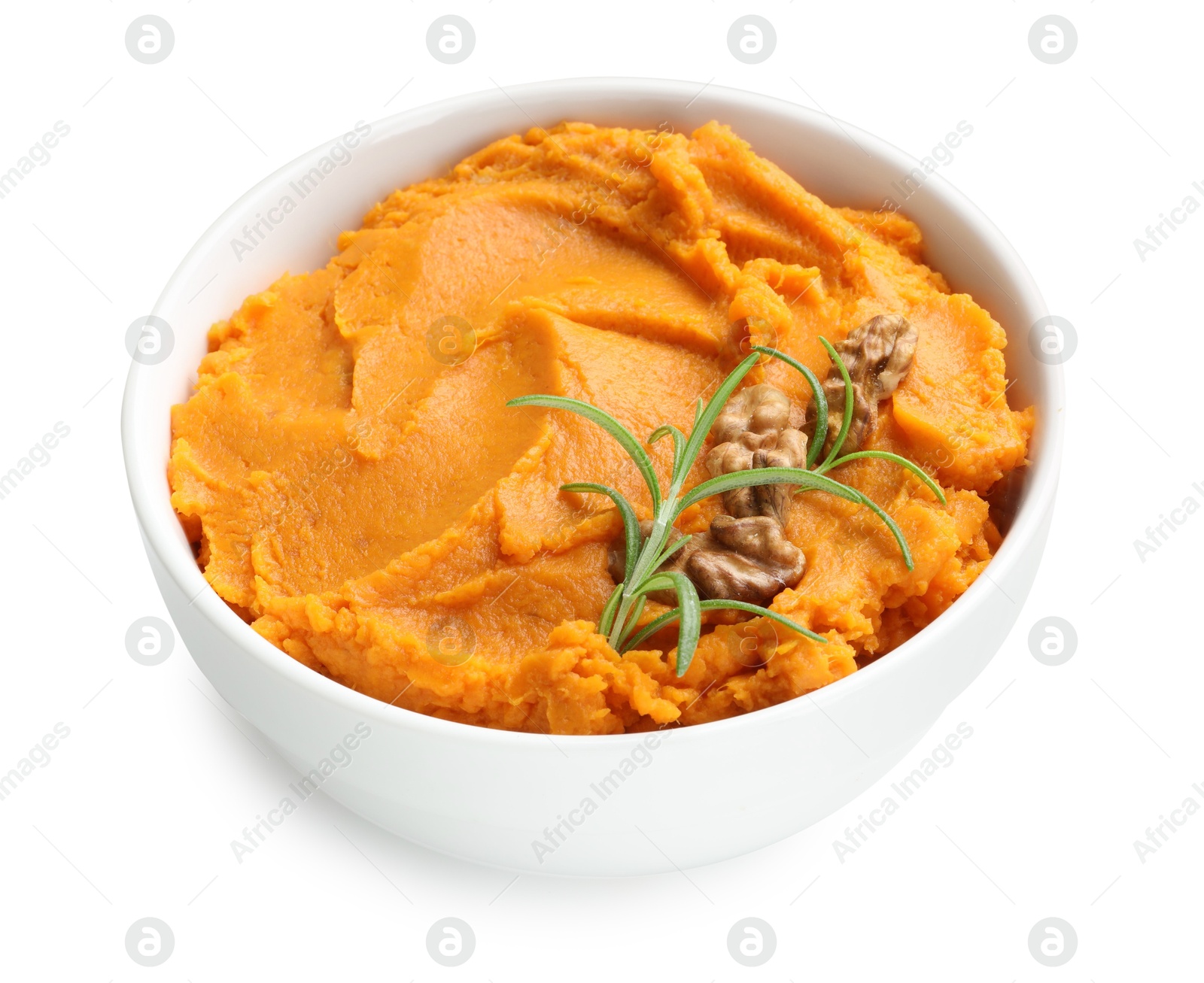 Photo of Delicious mashed sweet potatoes with walnuts and rosemary in bowl isolated on white