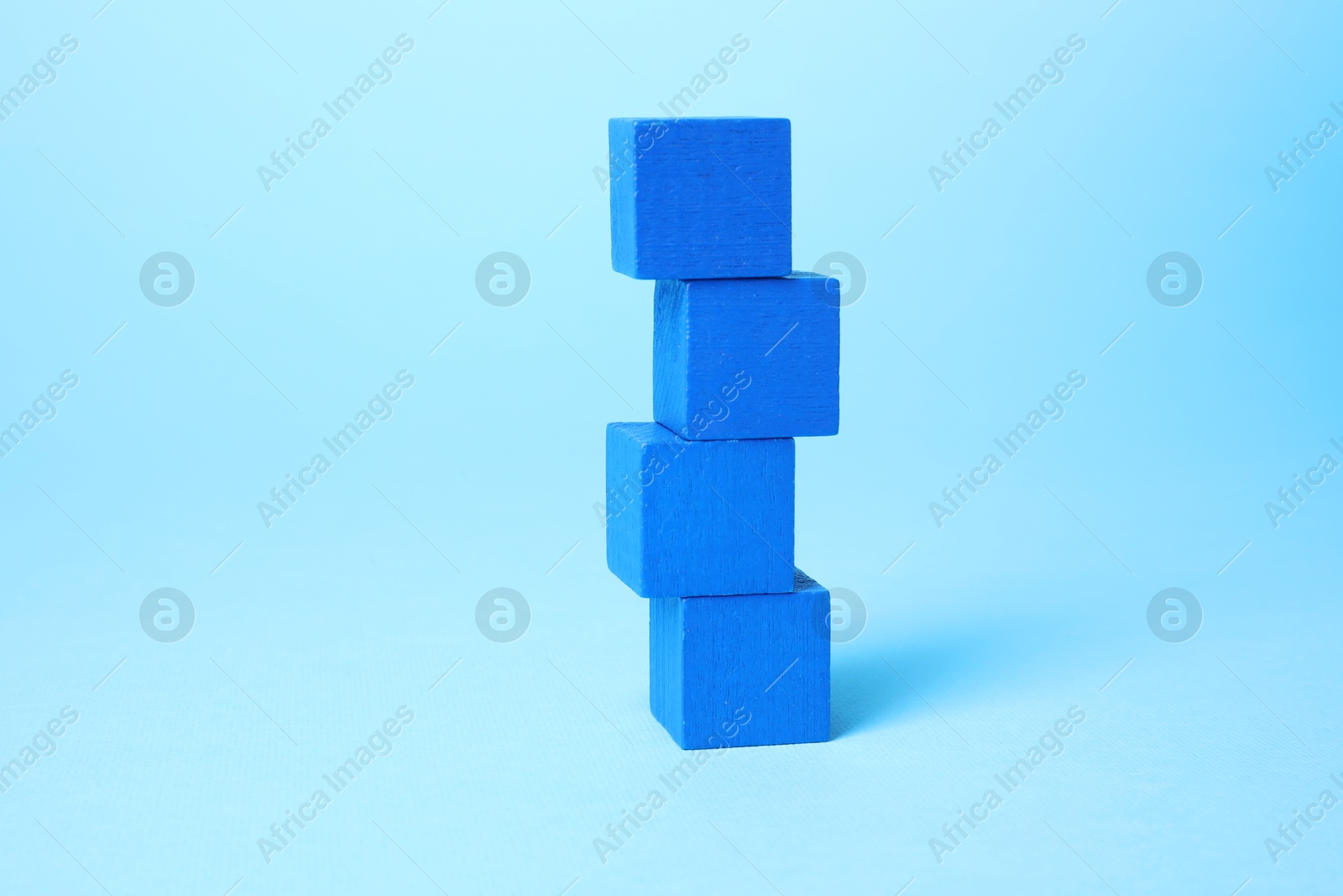 Photo of Many blank colorful cubes on light blue background