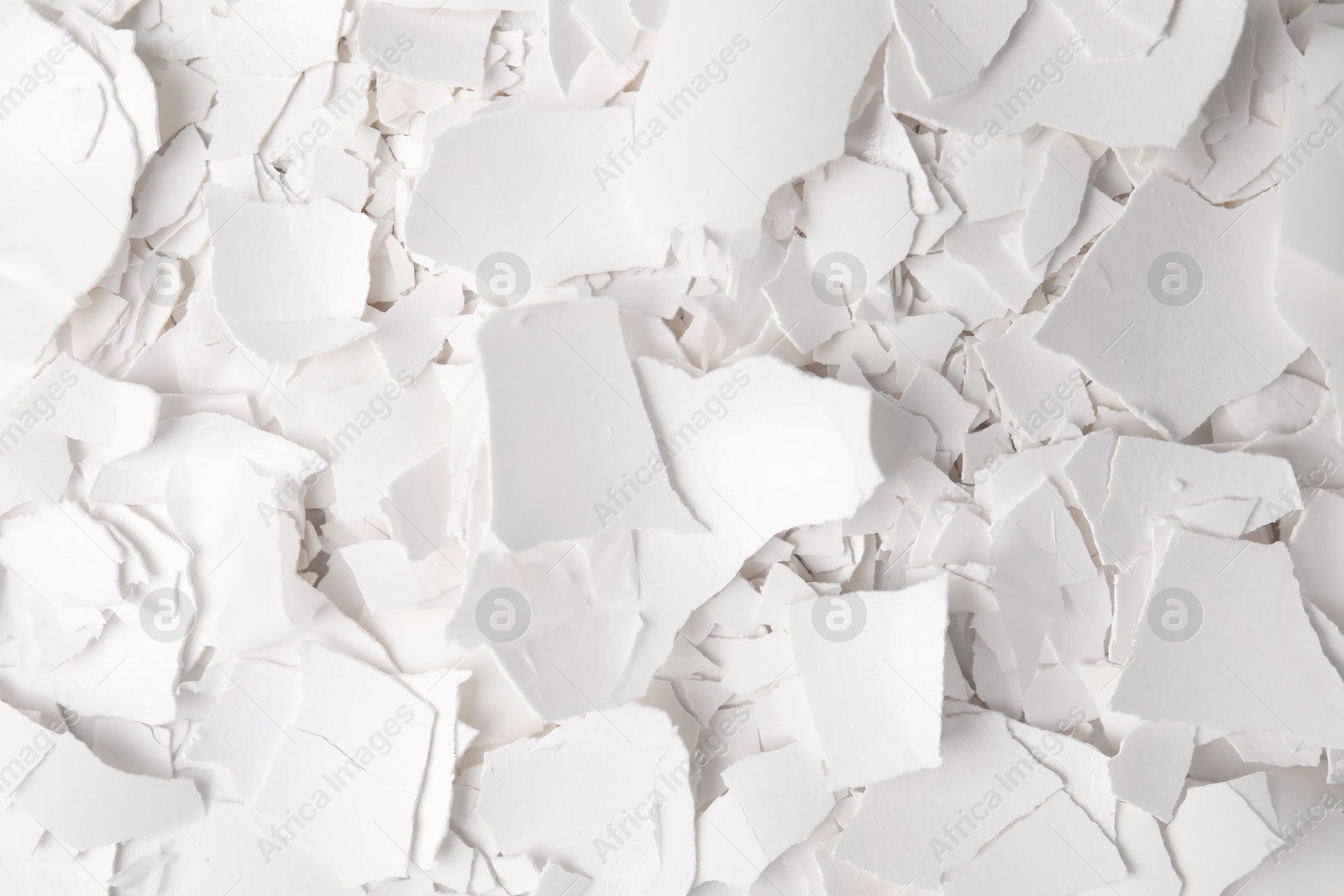 Photo of Pieces of broken eggshells as background, top view