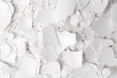 Photo of Pieces of broken eggshells as background, top view