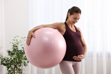 Photo of Beautiful pregnant woman with fitball at home