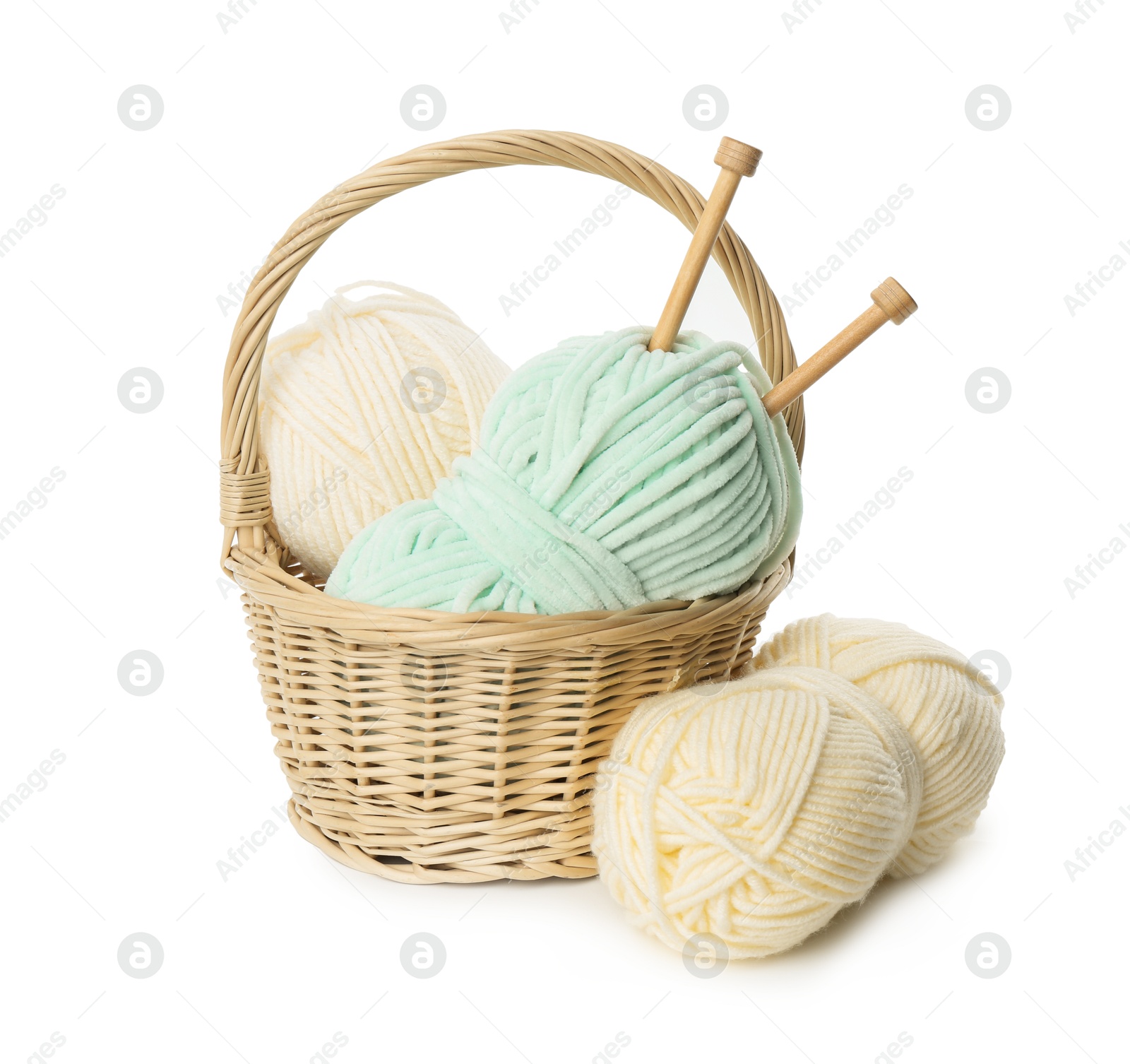 Photo of Skeins of soft yarn and knitting needles isolated on white