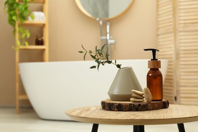 Personal care product, stones and vase on table in bathroom