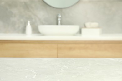 Photo of Empty light grey marble table in bathroom. Space for design