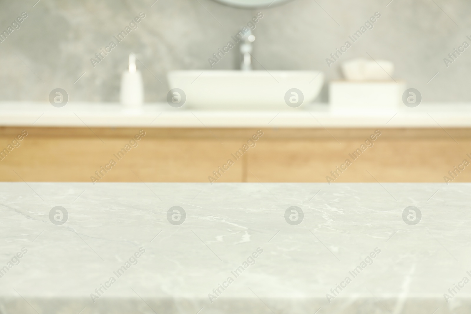 Photo of Empty light grey marble table in bathroom. Space for design