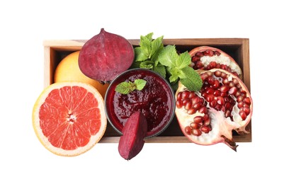 Glass of tasty beetroot smoothie, fresh vegetables, fruits and mint in wooden box isolated on white, top view. Vegan drink