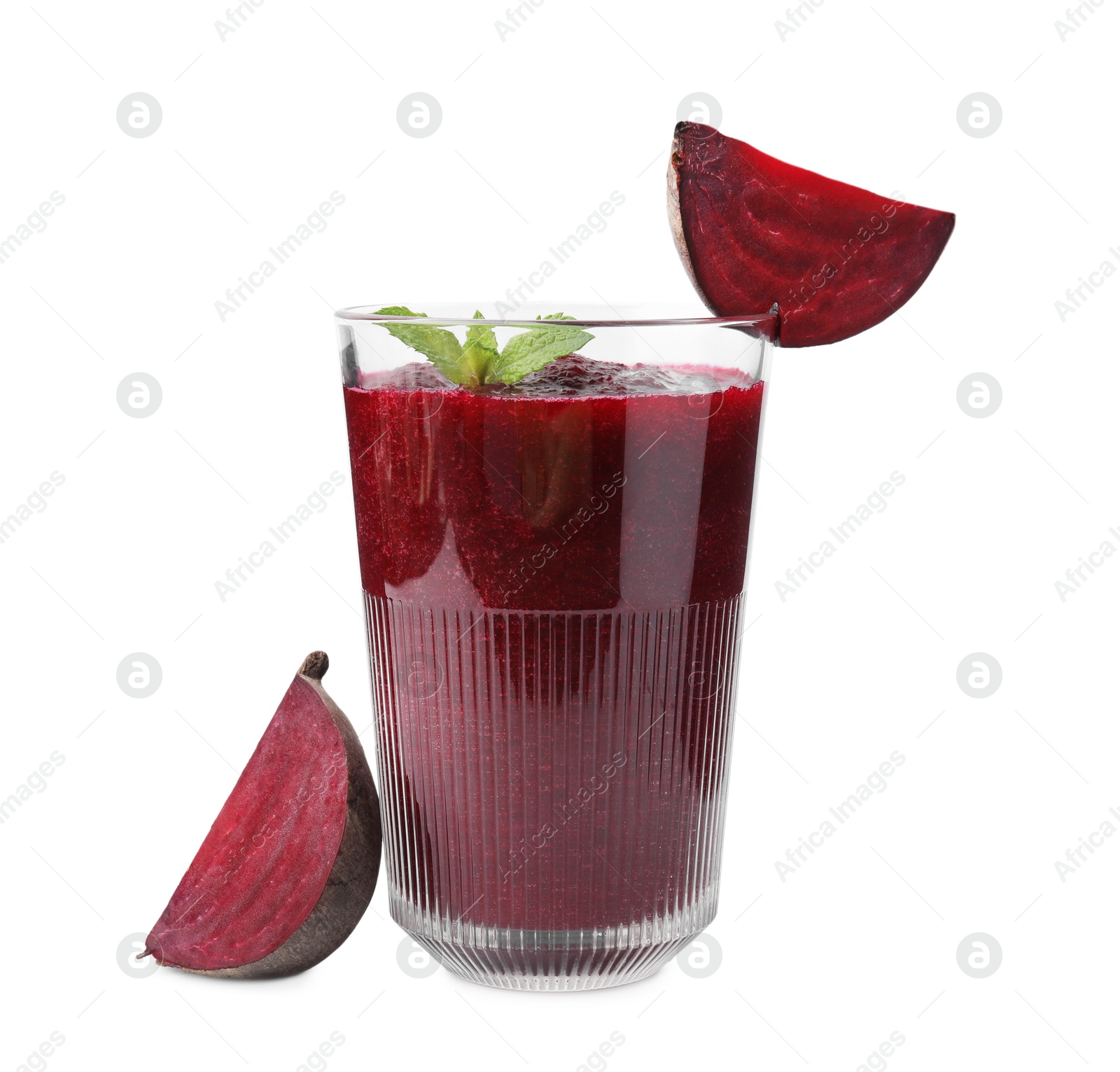 Photo of Tasty beetroot smoothie with mint in glass and pieces of fresh vegetable isolated on white. Vegan drink