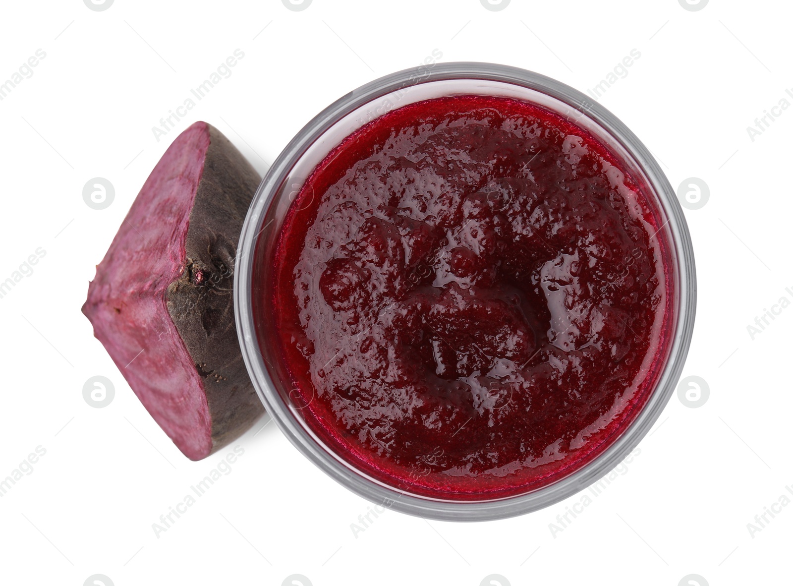 Photo of Tasty beetroot smoothie in glass and piece of fresh vegetable isolated on white, top view. Vegan drink