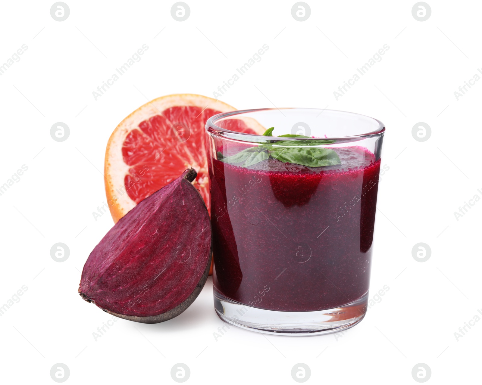 Photo of Tasty beetroot smoothie with basil in glass, fresh vegetable and grapefruit isolated on white. Vegan drink