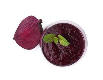 Tasty beetroot smoothie with mint in glass and piece of fresh vegetable isolated on white, top view. Vegan drink