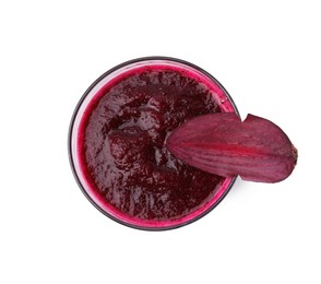 Photo of Tasty beetroot smoothie in glass and piece of fresh vegetable isolated on white, top view. Vegan drink