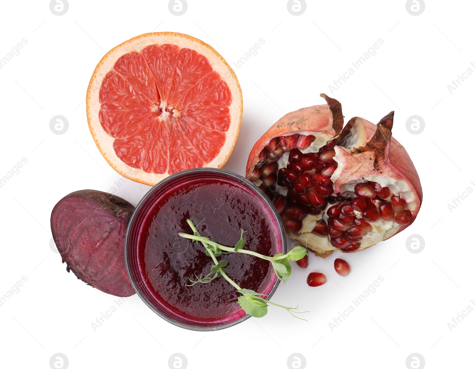 Photo of Tasty beetroot smoothie with microgreens in glass, fresh vegetable and fruits isolated on white, top view. Vegan drink