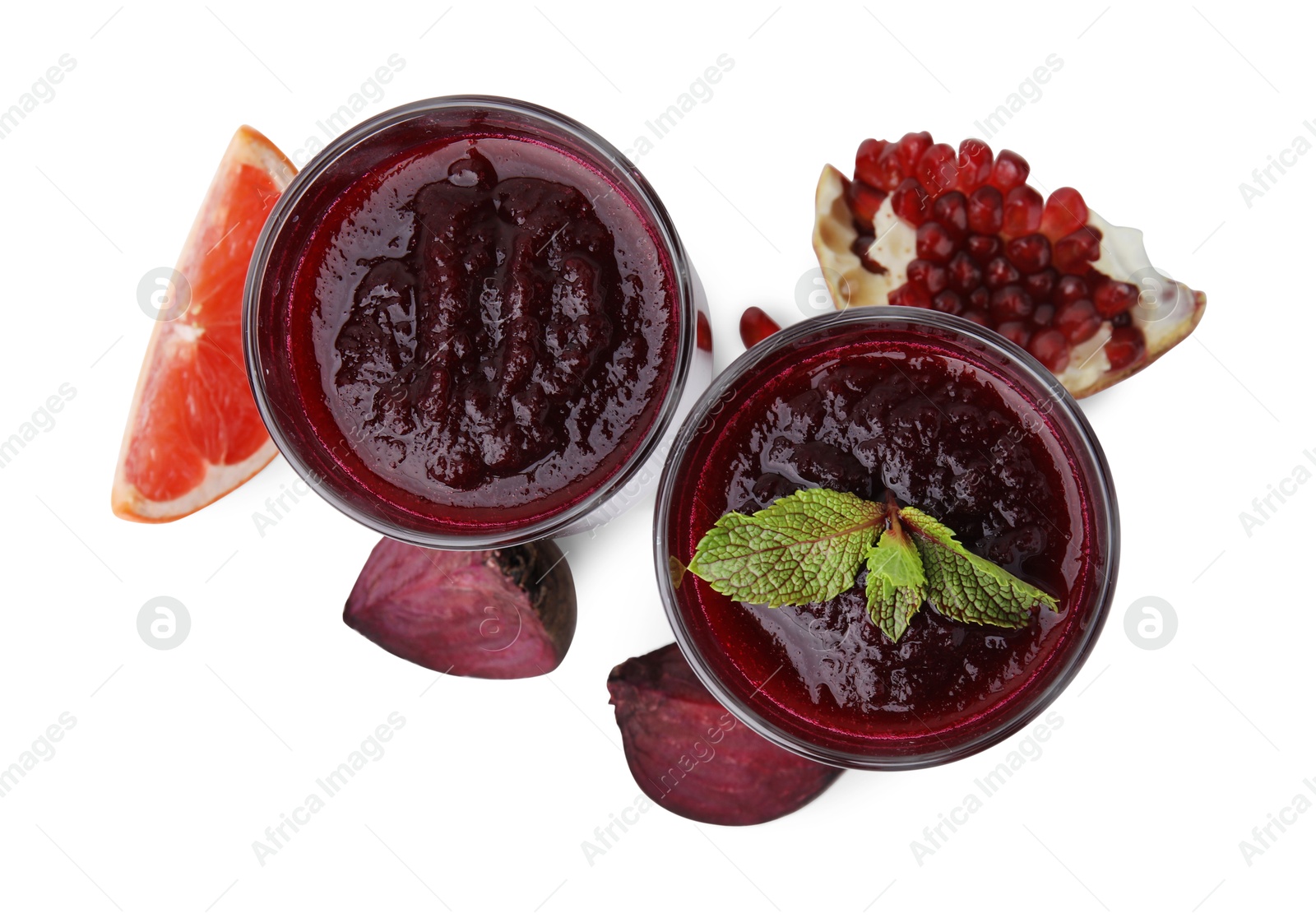 Photo of Fresh beetroot smoothie in glasses, grapefruit, beet and pomegranate isolated on white, top view